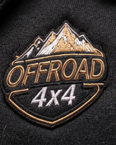 Detail of precise Offroad 4x4 embroidery with a mountain motif on a black hoodie